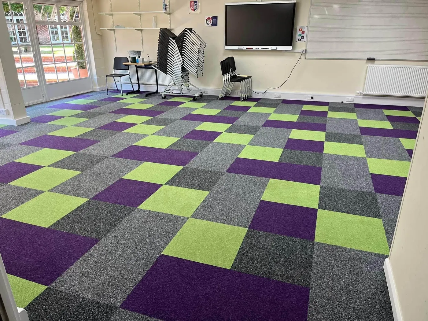 Freshly cleaned carpet tiles in a school classroom